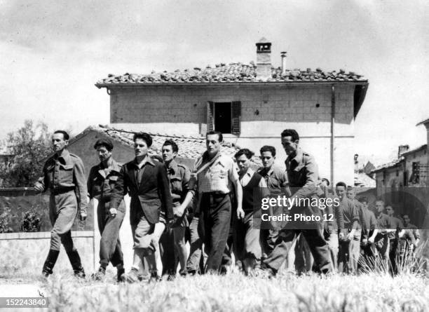 Italian partisans, some of those who helped fight the Germans and capture the local fascists, march outside the town of Montalcino , summer 1944.