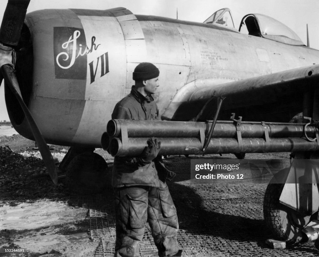 A Sergeant Of The 1st Tactical Air Force Installs A Rocket Tubes Onto a-sergeant-of-the-1st-tactical-air-force-installs-a-rocket-tubes-onto