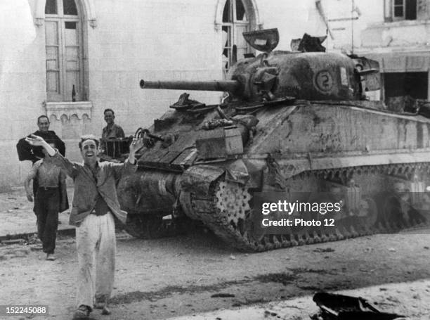 Scene in a Messina street as a civilian welcomed the arrival of Allied forces in the the Sicilian city , In background, a US, Army, Sherman tank .