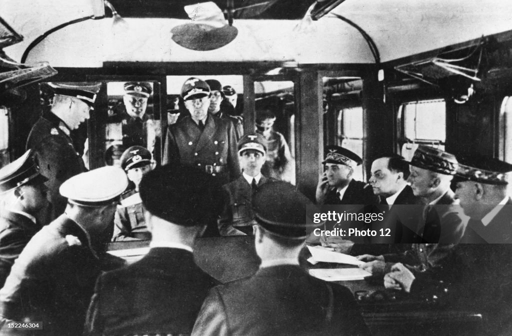 World War II, Signing of the armistice at Rethondes, France, in the forest of Compiegne, On the l, Hitler, in the middle, Leon Noel, Marshal Petain's ambassador in Warsaw, on his l, General Charles Huntziger, June 22, 1940.