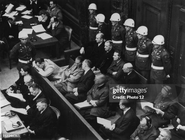 During the reading of indictment against them are left to right and front row, Hermann Goering, Rudolf Hess, von Ribbentrop, Keitel, Rosenberg, Hans...