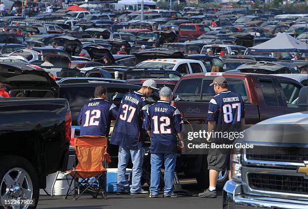 New England Patriots fans show their colors as they set up for tailgating in the parking lot at Patriot Place before the Patriots play the Arizona...