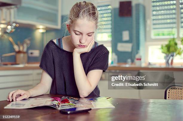 teenage girl reading - magazines on table stock pictures, royalty-free photos & images