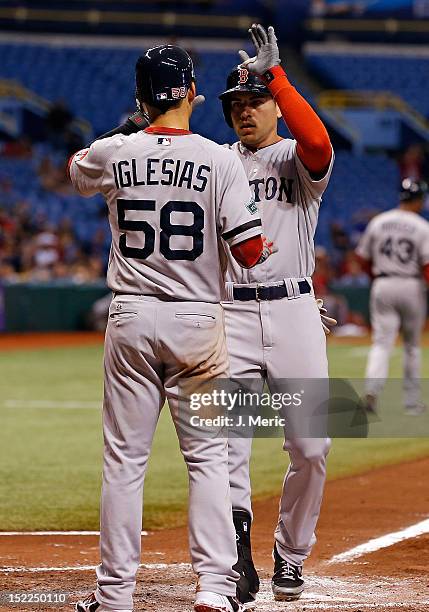 Infielder Jose Iglesias of the Boston Red Sox congratulates Jacoby Ellsbury after his home run against the Tampa Bay Rays during the game at...