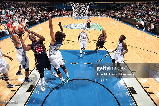 Jessica Davenport of the Indiana Fever shoots the ball against Seimone Augustus and Maya Moore of the Minnesota Lynx during the WNBA game on...