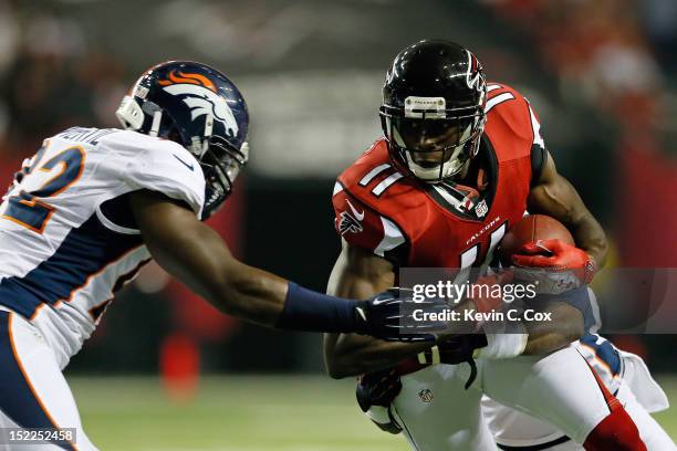 Wide receiver Julio Jones of the Atlanta Falcons catches a pass against defensive end Elvis Dumervil of the Denver Broncos during a game at the...