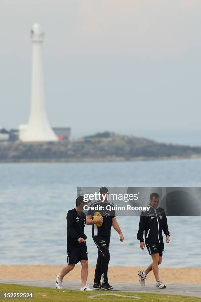 Alan Didak and Chris Dawes of the Magpies walk along the beach during a Collingwod Magpies AFL recovery sessionat the St Kilda Sea Baths on September...