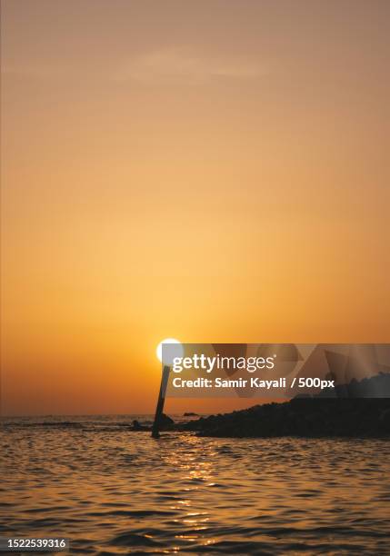 silhouette of boat in sea against sky during sunset,byblos,lebanon - byblos stock pictures, royalty-free photos & images