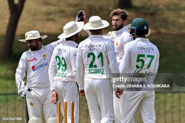 Pakistan's Shaheen Afridi celebrates with teammates after taking the wicket of Sri Lanka Cricket President's XI Praveen Jayawickrama during the first...