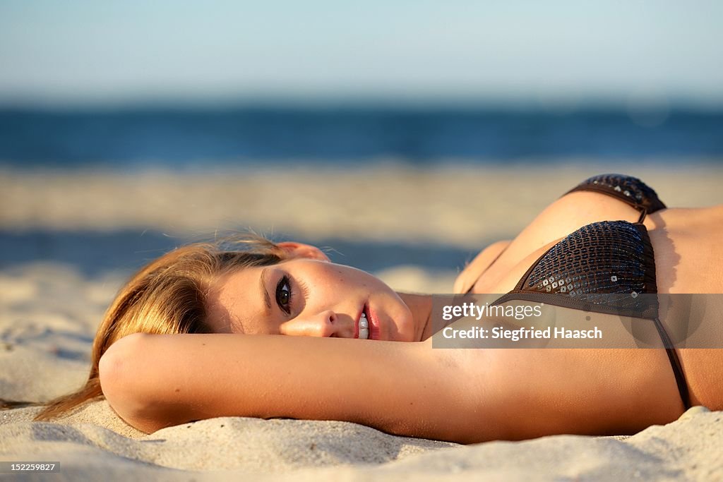 Woman lying on beach