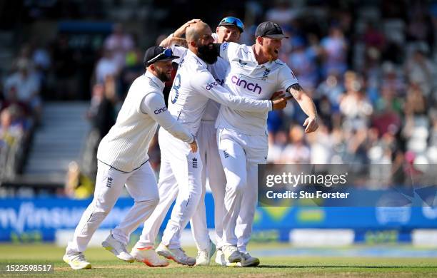 Moeen Ali of England is congratulated captain Ben Stokes after dismissing Marnus Labuschagne of Australia during Day Two of the LV= Insurance Ashes...