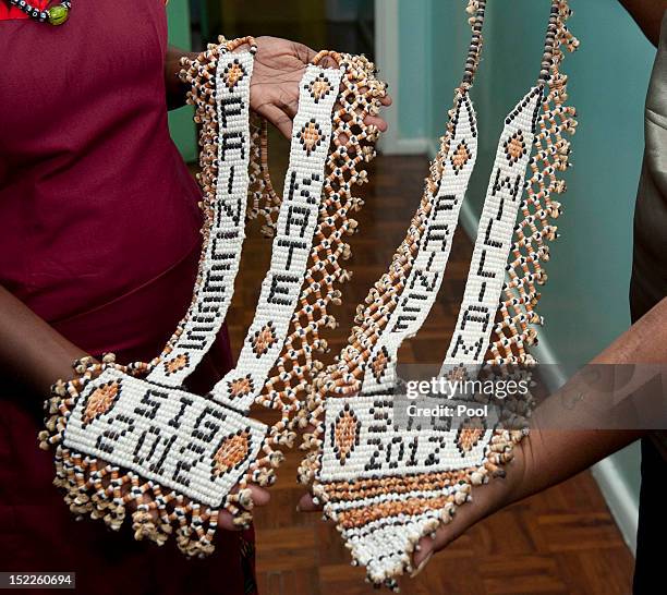 Personalised necklaces made for Prince William, Duke of Cambridge and Catherine, Duchess of Cambridge are presented to them as they visit the Prime...