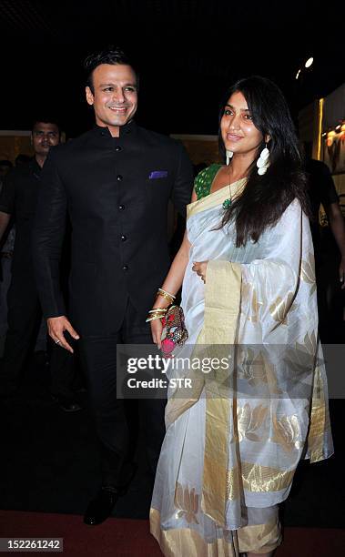 Indian Bollywood film actor Vivek Oberoi with wife attends the Grand Finale of Aamby Valley India Bridal Fashion Week 2012 in Mumbai on September 17,...