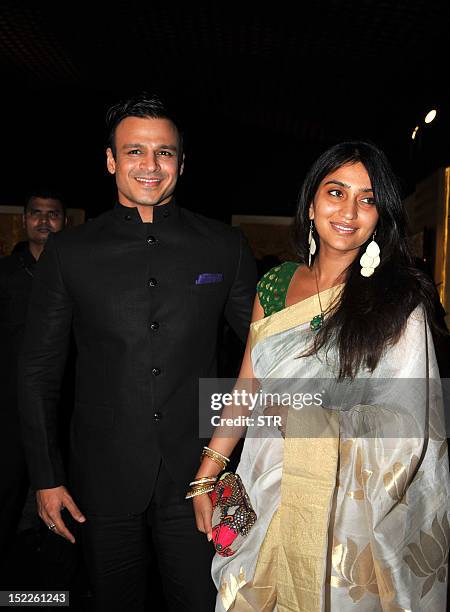 Indian Bollywood film actor Vivek Oberoi with wife attends the Grand Finale of Aamby Valley India Bridal Fashion Week 2012 in Mumbai on September 17,...
