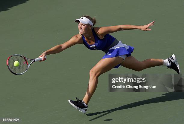 Caroline Wozniacki of Denmark plays a shot against Arantxa Ros of Netherlands during day one of the KDB Korea Open at Olympic Park Tennis Stadium on...