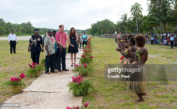 Prince William, Duke of Cambridge and Catherine, Duchess of Cambridge meet locals in Honiara on their way to Tivanipupu on day 7 of their Diamond...