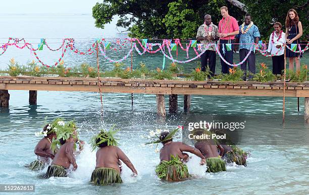 Catherine, Duchess of Cambridge and Prince William, Duke of Cambridge greet locals as they arrive in Honiara on their way to Tivanipupu on day 7 of...