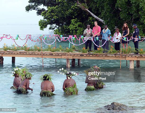 Catherine, Duchess of Cambridge and Prince William, Duke of Cambridge greet locals as they arrive in Honiara on their way to Tivanipupu on day 7 of...