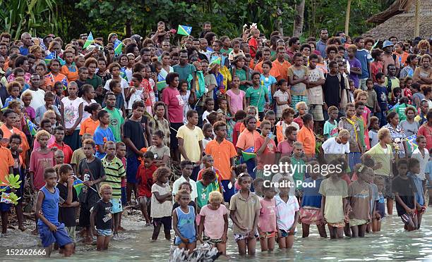 Locals wait for the arrival of Catherine, Duchess of Cambridge and Prince William, Duke of Cambridge as they arrive in Honiara on their way to...