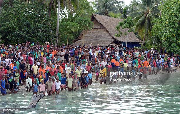 Locals wait for the arrival of Catherine, Duchess of Cambridge and Prince William, Duke of Cambridge as they arrive in Honiara on their way to...