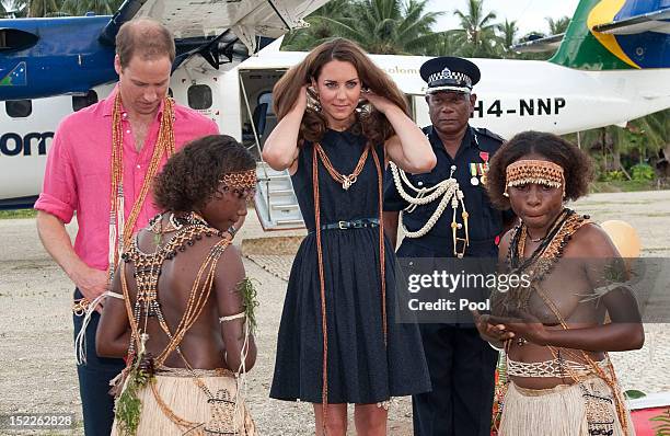 Prince William, Duke of Cambridge and Catherine, Duchess of Cambridge are seen after being presented with garlands as they arrive in Honiara on their...