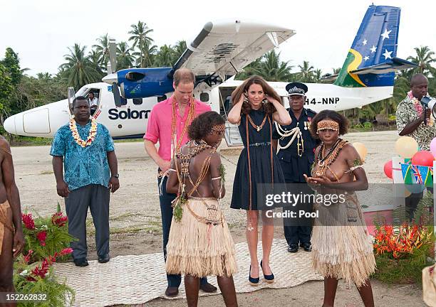 Prince William, Duke of Cambridge and Catherine, Duchess of Cambridge are seen after being presented with garlands as they arrive in Honiara on their...