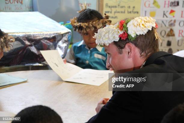 Britain's Prince William speaks to students as he visits the Nauti Primary School, the main government primary school in Tuvalu during a visit with...