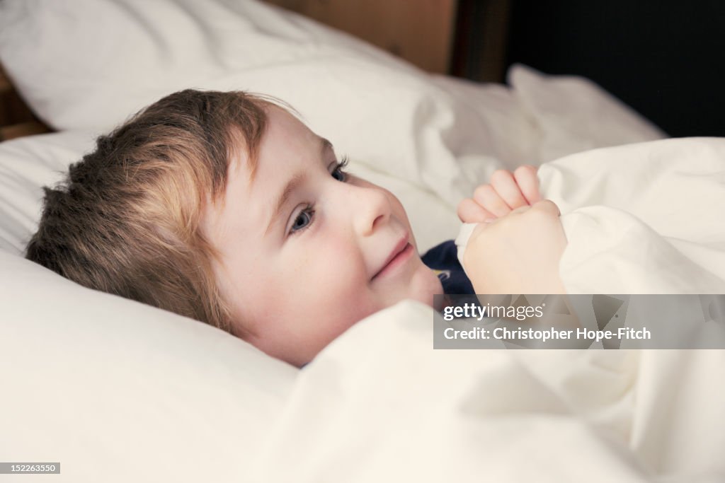 Boy lying on bed