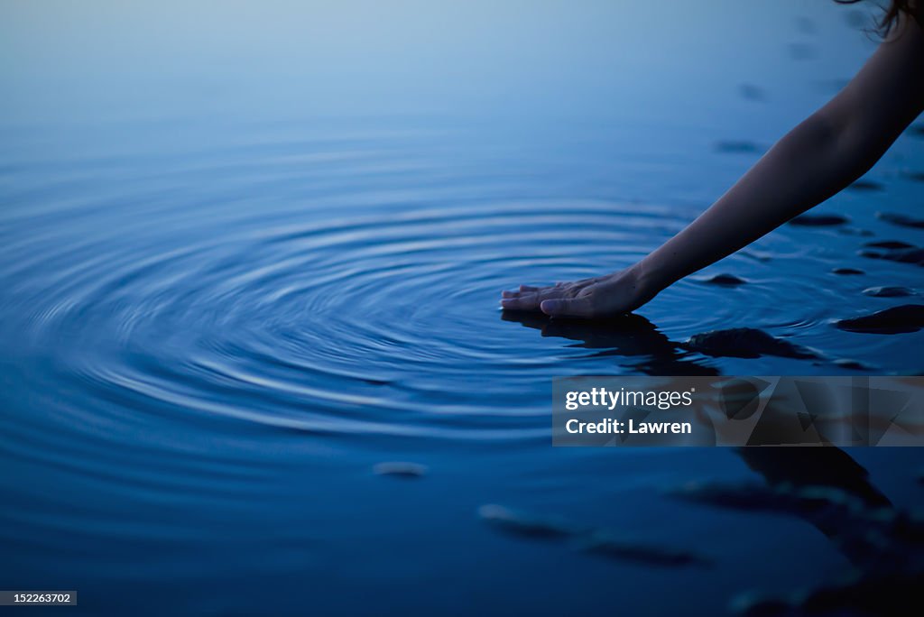 Hand and ripples. Zen concept.