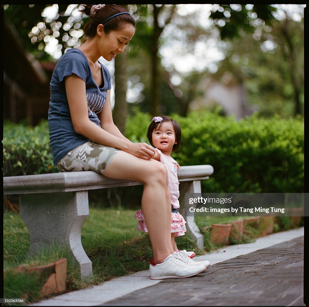 Young mother talking to joyful baby