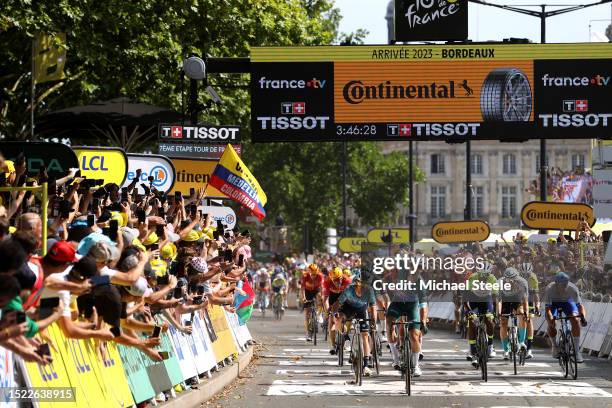 General view of Jasper Philipsen of Belgium and Team Alpecin-Deceuninck - Green points jersey celebrates at finish line as stage winner ahead of Mark...