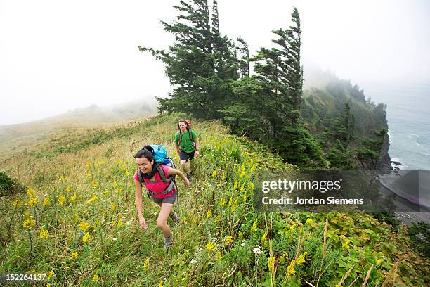 a man and woman backpacking. - lincoln city oregon stock pictures, royalty-free photos & images