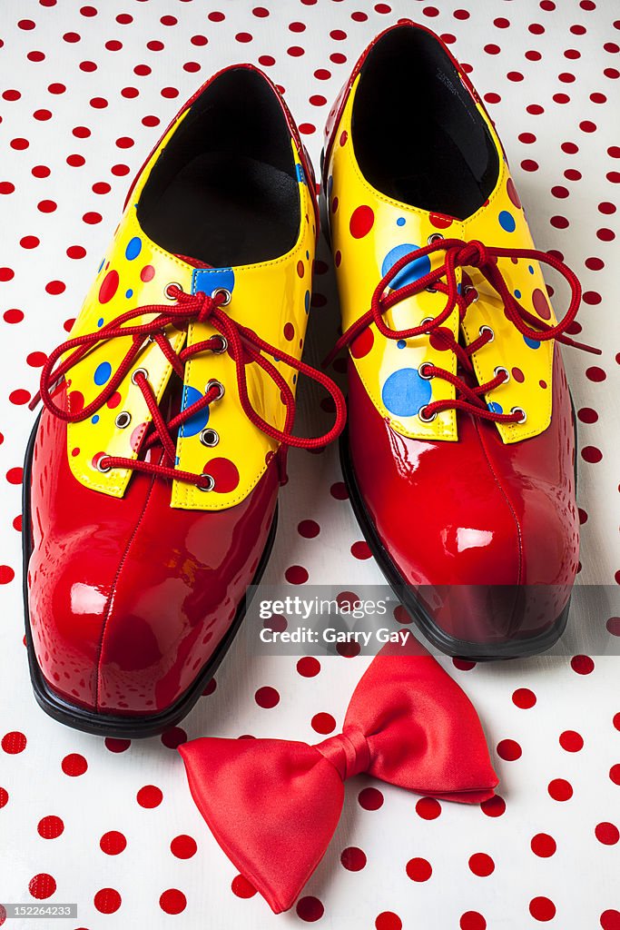 Clown shoes and a red bow tie