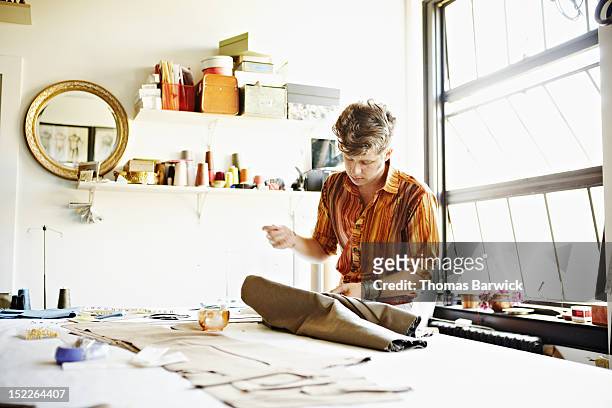 Male fashion designer at workbench in studio