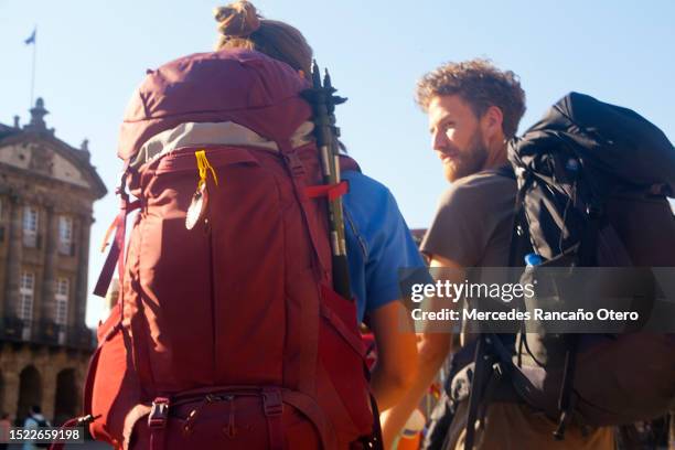 pellegrini che camminano in piazza obradoiro, santiago de compostela. - pellegrino foto e immagini stock