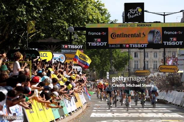 General view of Jasper Philipsen of Belgium and Team Alpecin-Deceuninck - Green points jersey celebrates at finish line as stage winner ahead of Mark...