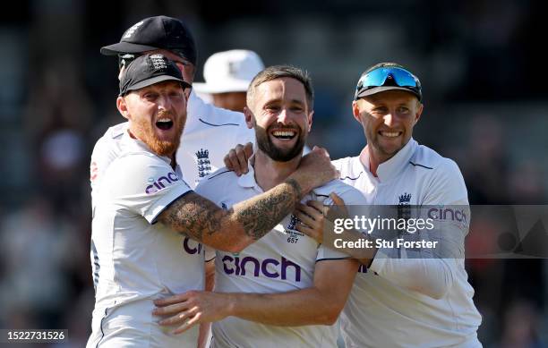 Chris Woakes of England celebrates with teammates Ben Stokes and Joe Root after dismissing Usman Khawaja of Australia during Day Two of the LV=...