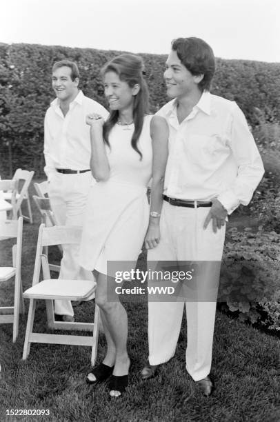 Todd Meister, Elizabeth Guber, and David Schulhof attend an event at the Schulof residence in East Hampton, New York, on August 9, 1993.