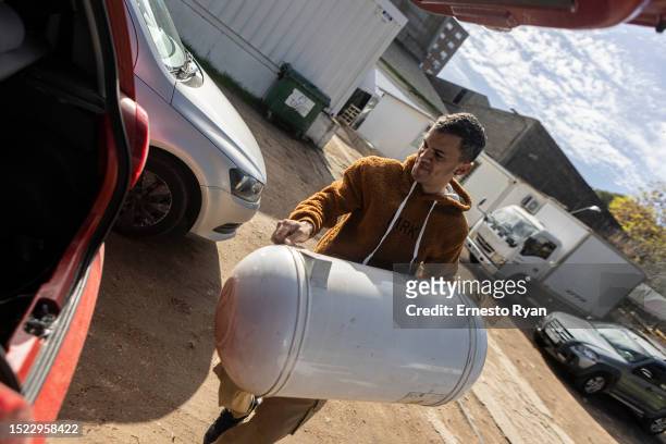 Man loads a water heater to his car after its repair as a demand in their repairs surges due to the high salinity in the tap water which causes...