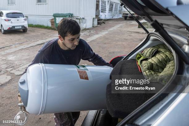 Man loads a water heater to his van after its repair as a demand in their repairs surges due to the high salinity in the tap water which causes...
