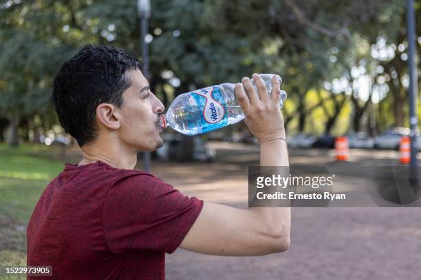 Runner hydrates with bottled water as tap water contains high salinity and chemicals on July 07, 2023 in Montevideo, Uruguay. The country faces its...