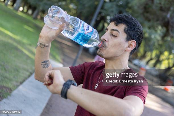 Runner hydrates with bottled water as tap water contains high salinity and chemicals on July 07, 2023 in Montevideo, Uruguay. The country faces its...