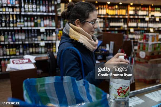 Woman buys bottled water in a supermarkets as tap water contains high salinity and chemicals on July 06, 2023 in Montevideo, Uruguay. The country...