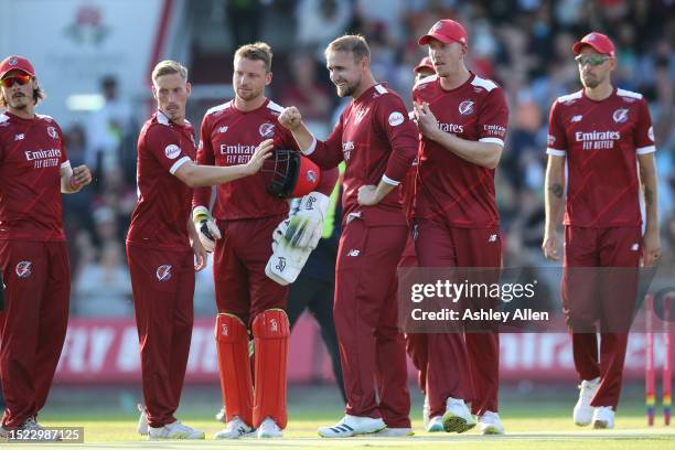 Liam Livingstone of Lancashire Lightning celebrates with teammates after bowling Laurie Evans of Surrey CCC during the Vitality Blast T20...