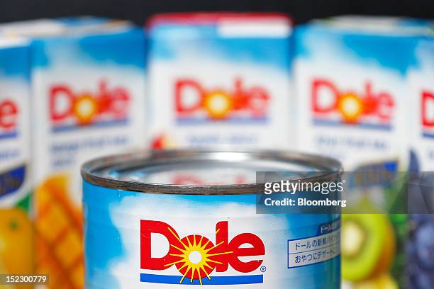 Can of Dole Food Co. Sliced pineapple is arranged for a photograph in front of cartons of the company's fruit juice in Soka City, Saitama Prefecture,...