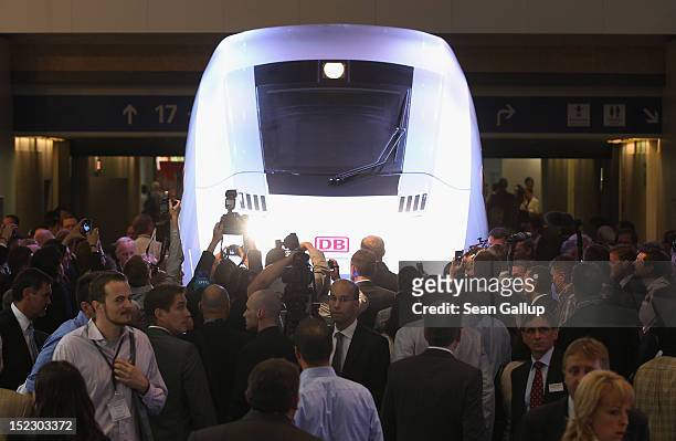 Visitors crowd around a mockup of the ICx, the latest generation of Deutsche Bahn high-speed trains, shortly after it was unveiled it at the...