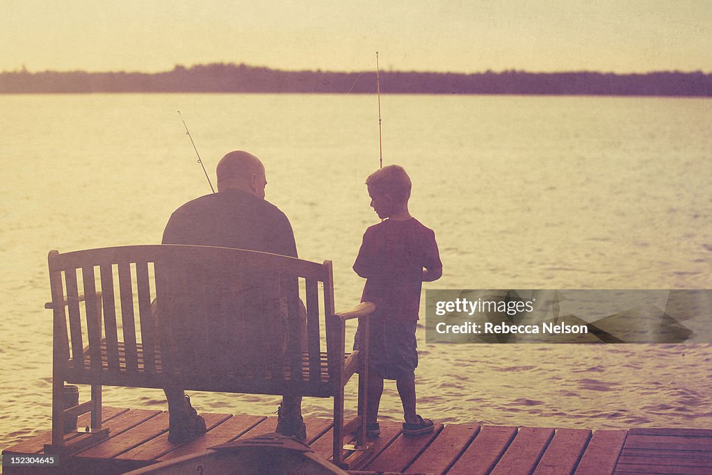Father and son fishing onpier