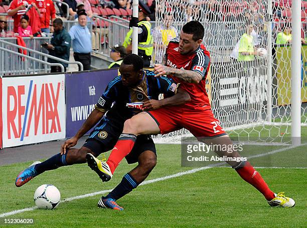 Eric Hassli of Toronto FC battles with Amobi Okugo of the Philadelphia Union during MLS action at the BMO Field September 15, 2012 in Toronto,...