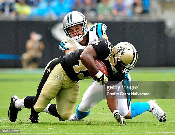 Haruki Nakamura of the Carolina Panthers tackles Darren Sproles of the New Orleans Saints during play at Bank of America Stadium on September 16,...