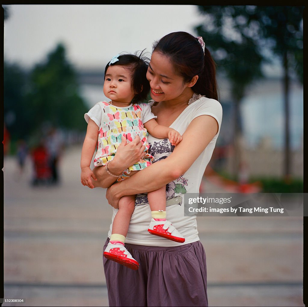 Young woman holding baby